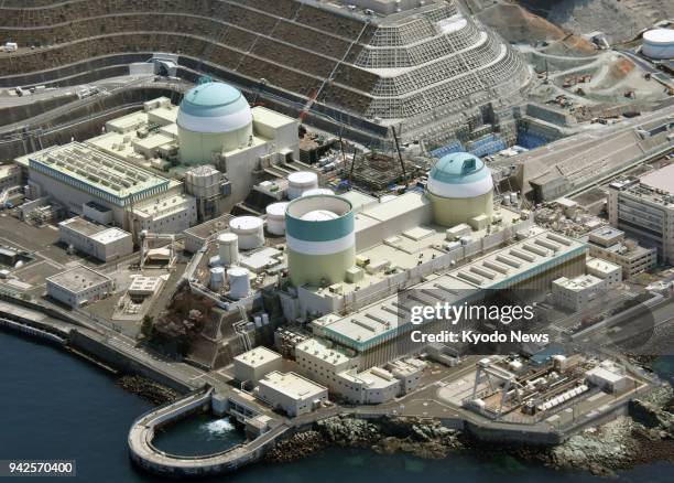 File photo taken from a Kyodo News helicopter on April 2 shows Nos. 3, 1 and 2 reactors of the Ikata nuclear power plant in Ehime Prefecture, western...