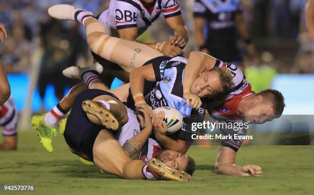 Matt Moylan of the Sharks is tacked by Dylan Napa and Jared Waerea-Hargreaves of the Roosters during the round five NRL match between the Cronulla...