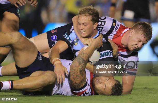 Matt Moylan of the Sharks is tacked by Dylan Napa and Jared Waerea-Hargreaves of the Roosters during the round five NRL match between the Cronulla...