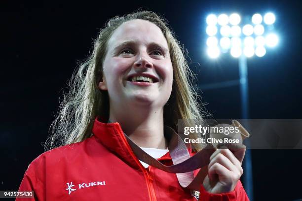 Gold medalist Sarah Vasey of England looks on during the medal ceremony for the Women's 50m Breaststroke Final on day two of the Gold Coast 2018...