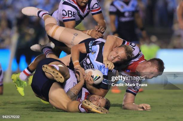 Matt Moylan of the Sharks is tacked by Dylan Napa and Jared Waerea-Hargreaves of the Roosters during the round five NRL match between the Cronulla...