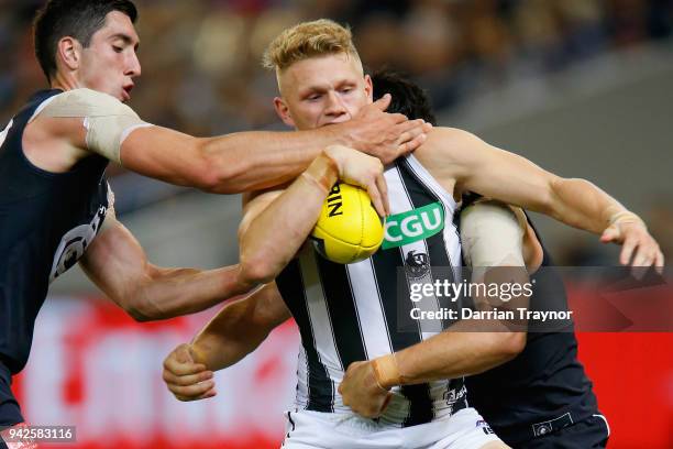 Adam Treloar of the Magpies is tackled by Jacob Weitering of the Blues during the round three AFL match between the Carlton Blues and the Collingwood...