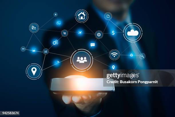 businessman hand holding smart phone.virtual digital technology concept,social media - email icon stock-fotos und bilder