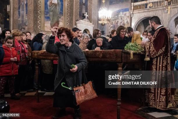 Bulgarian Eastern Orthodox believers pray during a Good Friday service at Alexander Nevsky Cathedral in Sofia on April 6, 2018. / AFP PHOTO / Dimitar...