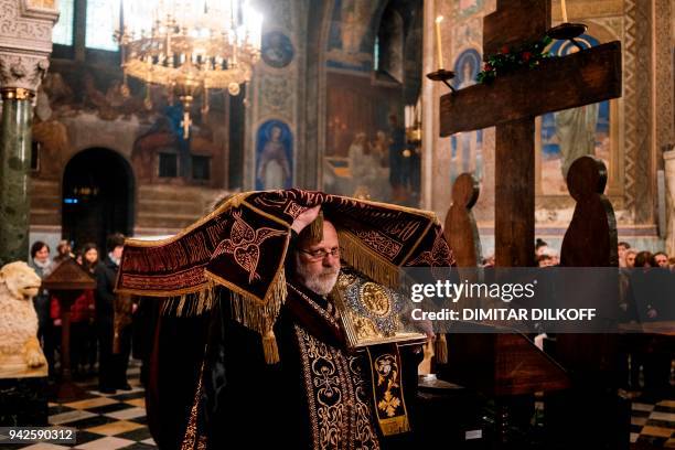 Bulgarian Eastern Orthodox priest takes part in the traditional Good Friday service at Alexander Nevsky Cathedral in Sofia on April 6, 2018. / AFP...