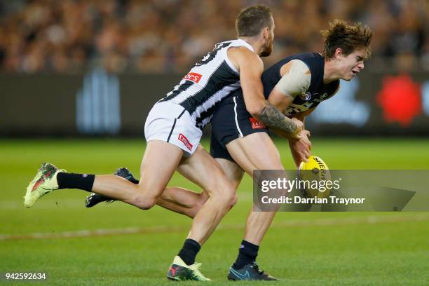 Jeremy Howe of the Magpies tackles Paddy Dow of the Blues during the round three AFL match between the Carlton Blues and the Collingwood Magpies at...