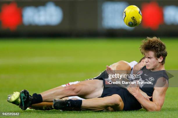 Jeremy Howe of the Magpies tackles Paddy Dow of the Blues during the round three AFL match between the Carlton Blues and the Collingwood Magpies at...