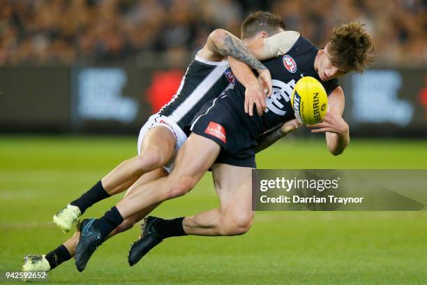 Jeremy Howe of the Magpies tackles Paddy Dow of the Blues during the round three AFL match between the Carlton Blues and the Collingwood Magpies at...