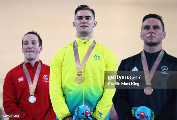 Silver medalist Lewis Oliva of Wales, gold medalist Matt Glaetzer of Australia and bronze medalist Edward Dawkins of New Zealand pose during the...