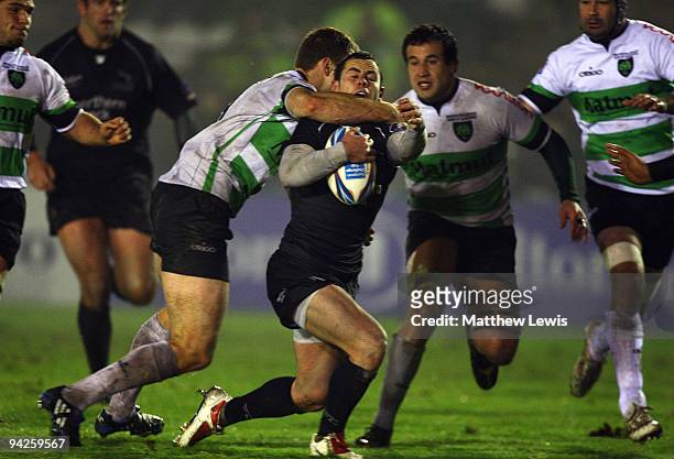Micky Young of Newcastleis tackled by Andrew Henderson of Montauban during the Amlin Challenge Cup match between Newcastle Falcons and Montauban at...