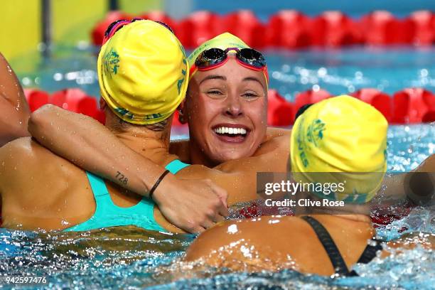 Brianna Throssell of Australia celebrates with teammates Madeline Groves and Emma Mckeon following the Women's 100m Butterfly Final on day two of the...
