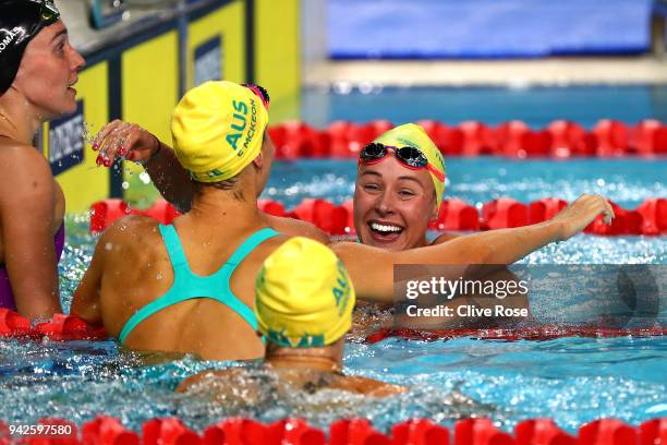 Brianna Throssell of Australia celebrates with teammates Madeline Groves and Emma Mckeon following the Women's 100m Butterfly Final on day two of the...