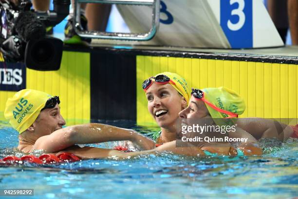 Emma McKeon of Australia celebrates with teammates Madeline Groves and Brianna Throssell following the Women's 100m Butterfly Final on day two of the...