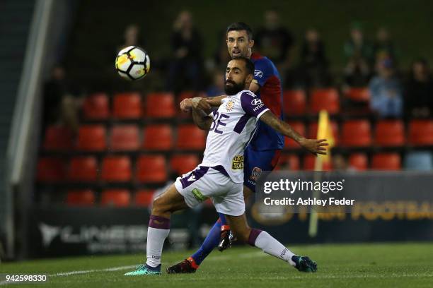 Diego Castro of Perth Glory is contesterd by Jason Hoffman of the Jets during the round 26 A-League match between the Newcastle jets and the Perth...