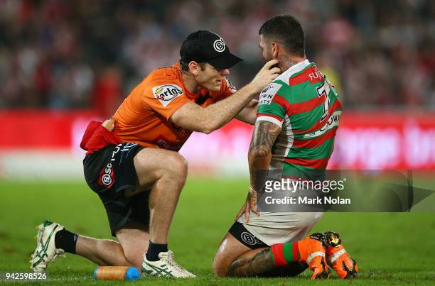 Adam Reynolds of the Rabbitohs receives attention during the round five NRL match between the St George Illawarra Dragons and the South Sydney...