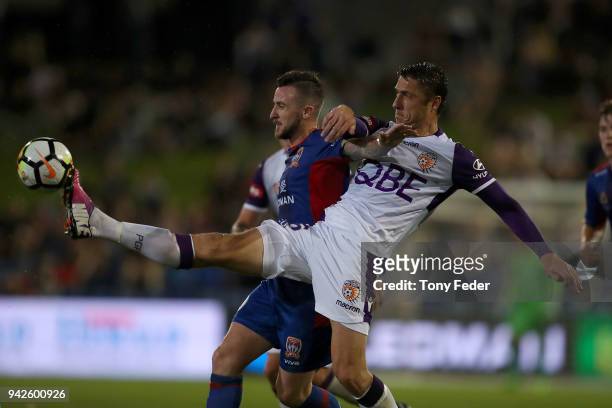 Roy O'Donovan of the Jets contests the ball with Dino Djulbic of the Glory during the round 26 A-League match between the Newcastle Jets and the...