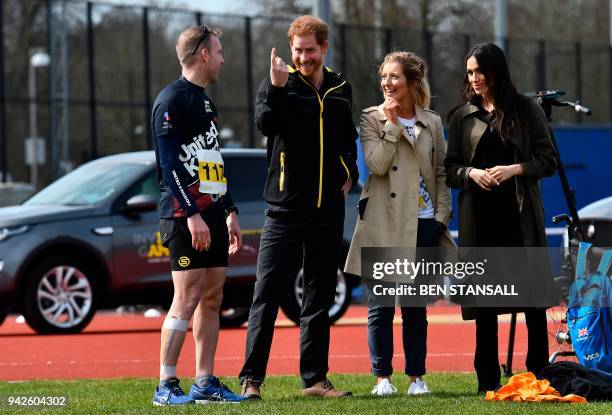 Britain's Prince Harry and his fiancee US actress Meghan Markle accompanied by Invictus Games UK Team Chef de Mission Jayne Kavanagh meet...