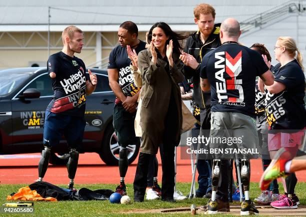 Britain's Prince Harry and his fiancee US actress Meghan Markle meet participants at the UK team trials for the Invictus Games Sydney 2018 at the...