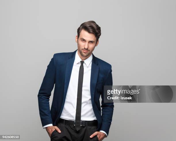 portrait of elegant young man in suit - male model facial expression stock pictures, royalty-free photos & images