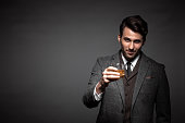 Portrait of handsome man drinking whiskey