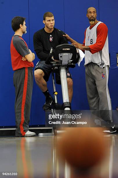 Blake Griffin and Brian Skinner of the Los Angeles Clippers chat with yoga therapist Kent Katich during a team practice on December 10, 2009 at the...