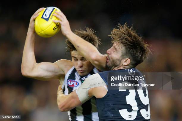 Josh Thomas of the Magpies marks the ball in front of Dale Thomas of the Blues during the round three AFL match between the Carlton Blues and the...