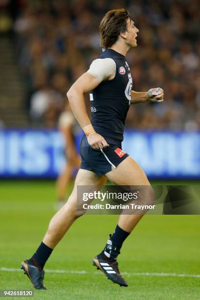 Caleb Marchbank of the Blues comes back onto the ground with an ankle brace on his injured root foot during the round three AFL match between the...