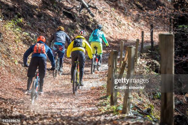 bikers riding mountain bikes - group selective focus stock pictures, royalty-free photos & images