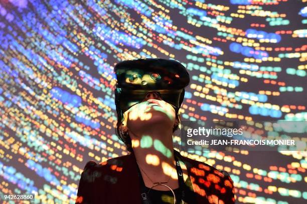 Visitor uses a Virtual Reality headset during the "Laval Virtual" virtual reality, augmented reality and 3D techonology show on April 6 in Laval,...