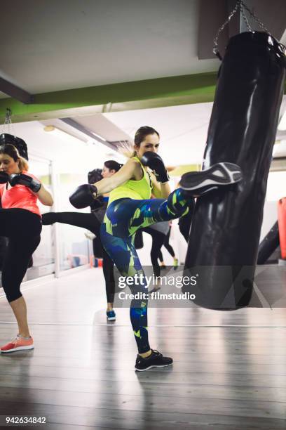 women practicing boxing in the gym - kickboxing fitness stock pictures, royalty-free photos & images