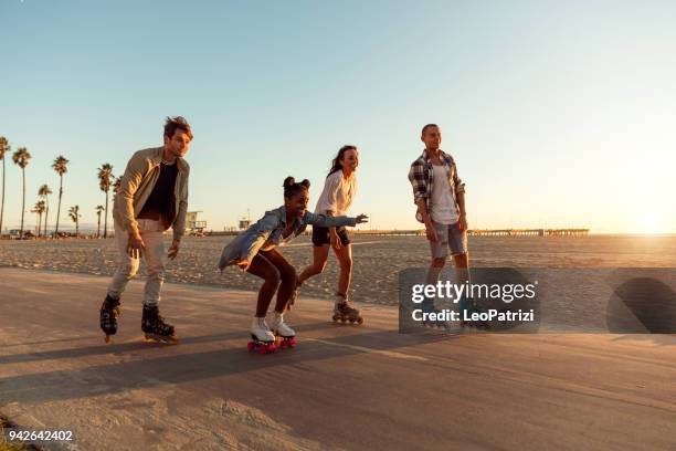 freunde beim rollschuhlaufen auf der uferpromenade in venice beach-santa monica promenade-los angeles, usa - city of los angeles stock-fotos und bilder