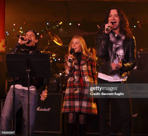 James Carpinello, Amy Spanger, and Constantine Maroulis perform during the holiday tree lighting at the New York Stock Exchange on December 10, 2009...
