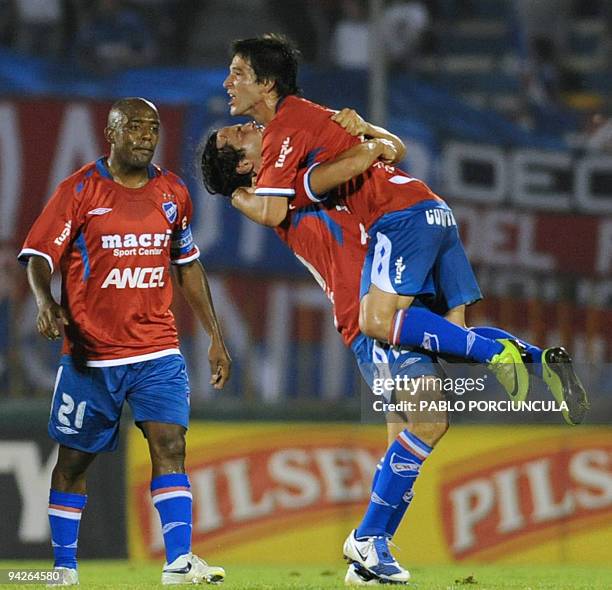 Nacional's Alvaro Gonzalez celebrates with teammate Nicolas Lodeiro his goal against Fenix during Uruguayan Apertura tournament football match in...