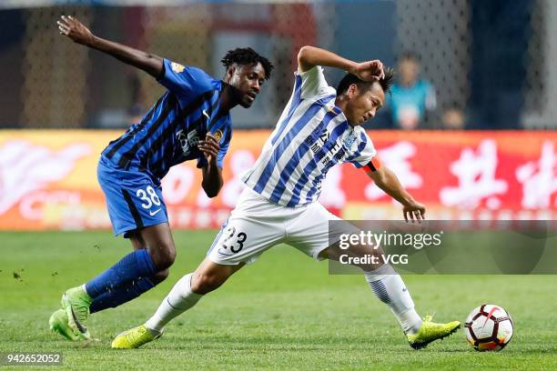 Lu Lin of Guangzhou R&F and Richmond Boakye of Jiangsu Suning compete for the ball during the 2018 Chinese Super League match between Guangzhou R&F...