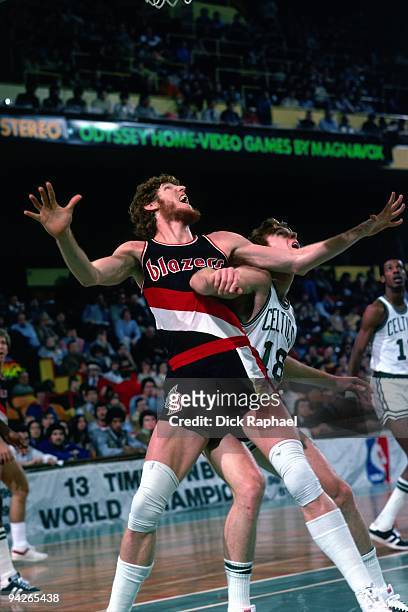 Bill Walton of the Portland Trail Blazers boxes out against Dave Cowens of the Boston Celtics during a game played in 1977 at the Boston Garden in...