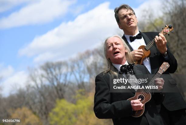 Musicians Dave Suich and Peter Brooke Turner of The Ukulele Orchestra of Great Britain play in Central Park on April 5, 2018 in New York City. The...