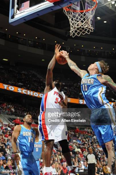 Jason Maxiell of the Detroit Pistons has his shot blocked by Chris Andersen of the Denver Nuggets in a game at the Palace of Auburn Hills on December...