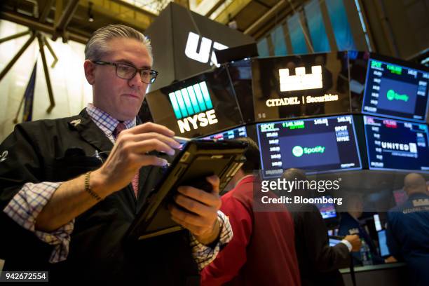 Trader works on the floor of the New York Stock Exchange in New York, U.S., on Friday, April 6, 2018. U.S. Stocks fell and Treasuries rose as...