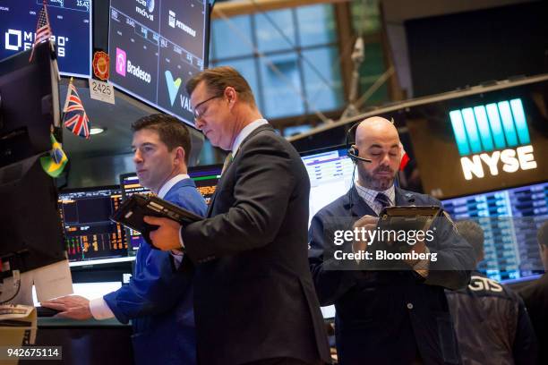 Traders work on the floor of the New York Stock Exchange in New York, U.S., on Friday, April 6, 2018. U.S. Stocks fell and Treasuries rose as...