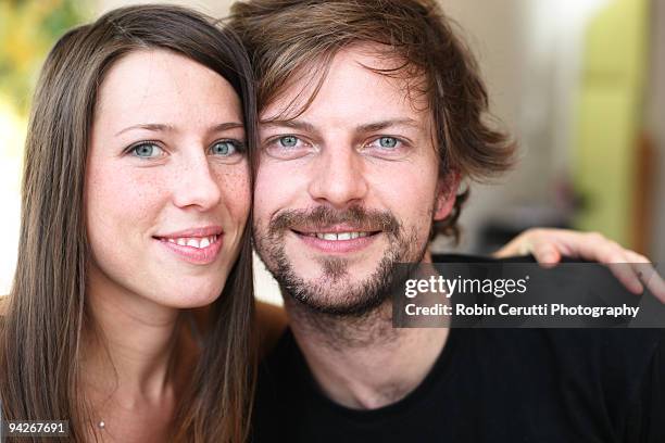 couple smiling at breakfast - guancia a guancia foto e immagini stock