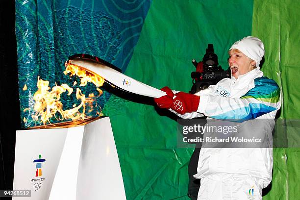 Guylaine Bernier, bearer of the Vancouver 2010 Torch Relay, lights the Olympic Flame at Place Jacques-Cartier on December 10, 2009 in Montreal,...