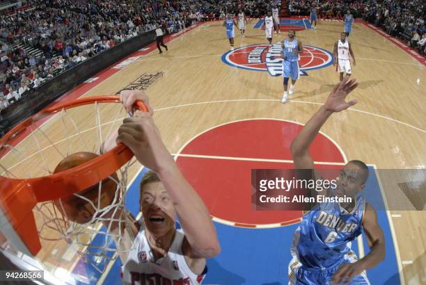 Jonas Jerebko of the Detroit Pistons dunks past Arron Afflalo of the Denver Nuggets in a game at the Palace of Auburn Hills on December 10, 2009 in...