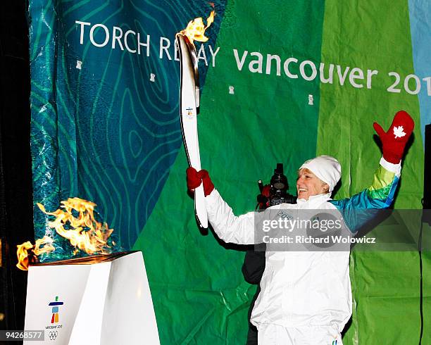 Guylaine Bernier, bearer of the Vancouver 2010 Torch Relay, lights the Olympic Flame at Place Jacques-Cartier on December 10, 2009 in Montreal,...