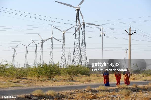 Young women in the field of wind mills situated in Jaisalmer region in Rajasthan on March 08, 2017 in India.