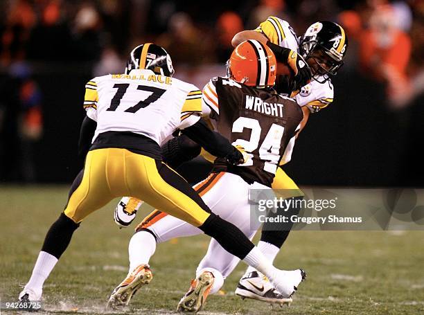 Eric Wright of the Cleveland Browns tackles Hines Ward of the Pittsburgh Steelers at Cleveland Browns Stadium on December 10, 2009 in Cleveland, Ohio.