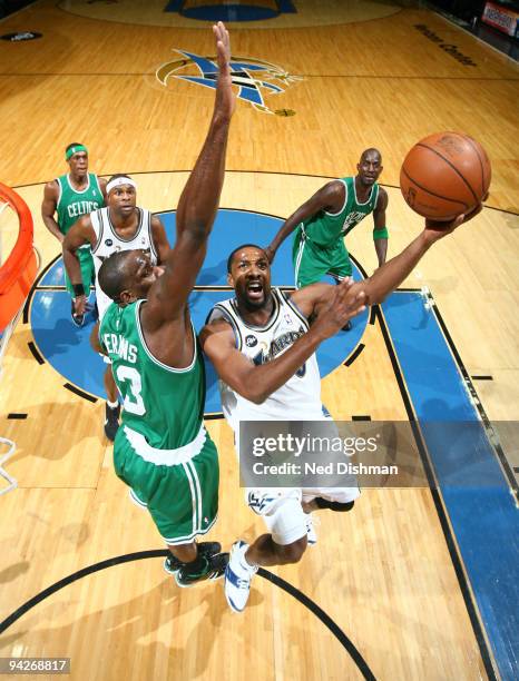 Gilbert Arenas of the Washington Wizards shoots against Kendrick Perkins of the Boston Celtics at the Verizon Center on December 10, 2009 in...