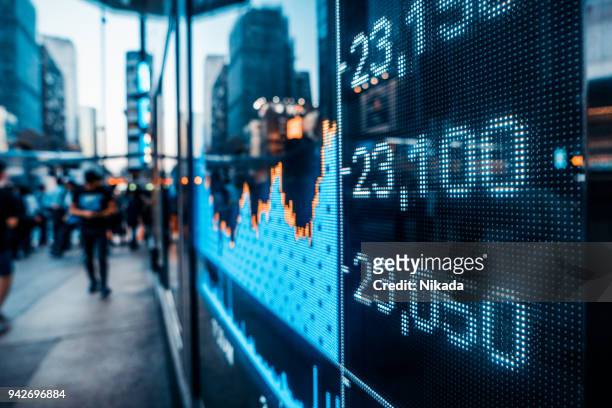 financial stock market numbers and city light reflection - news ticker imagens e fotografias de stock