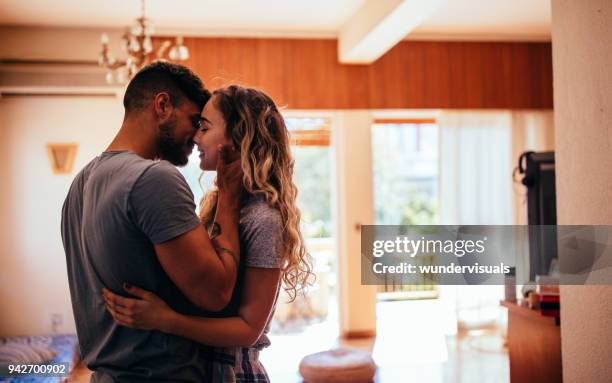 romantic young hipster couple kissing - pecking stock pictures, royalty-free photos & images