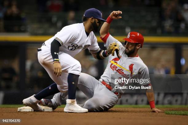 Matt Carpenter of the St. Louis Cardinals advances to second base on a wild pitch past Jonathan Villar of the Milwaukee Brewers in the seventh inning...