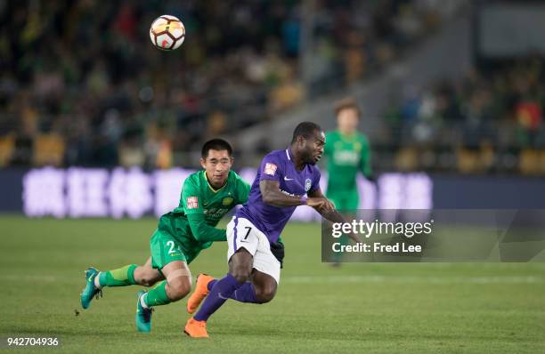 Frank Acheampong of Tianjin Teda FC and Zhang yu of Beijing Guoan in action during the 2018 Chinese Super League match between Beijing Guoan and...